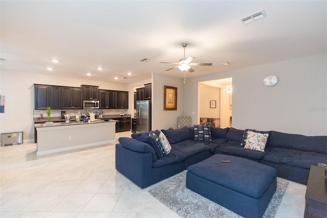 living room with ceiling fan and light tile patterned floors