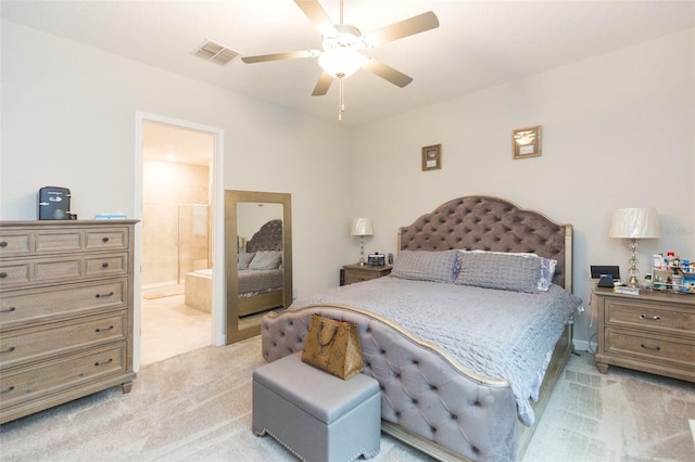 carpeted bedroom featuring ceiling fan and ensuite bath