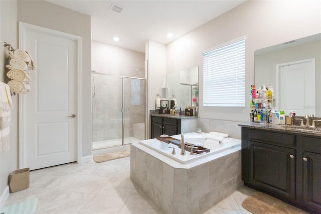 bathroom featuring tile patterned floors, plus walk in shower, and vanity