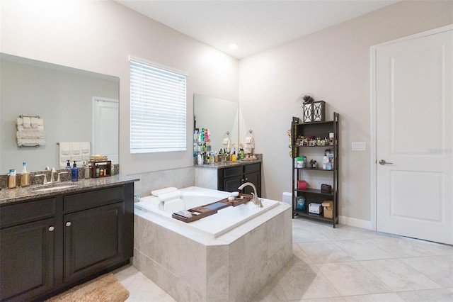 bathroom featuring vanity, tile patterned flooring, and tiled tub