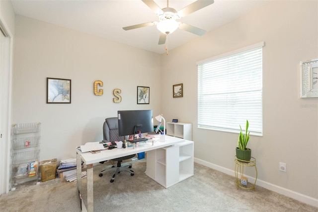 carpeted office space featuring a healthy amount of sunlight and ceiling fan