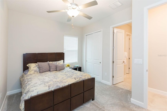 carpeted bedroom featuring a closet and ceiling fan