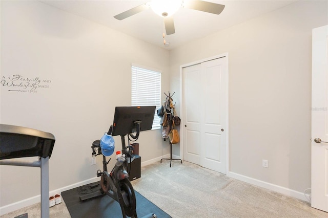 exercise area featuring light colored carpet and ceiling fan