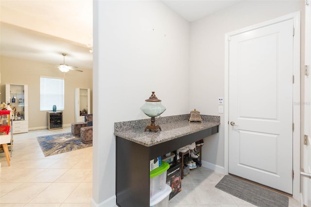 interior space with ceiling fan and light tile patterned floors