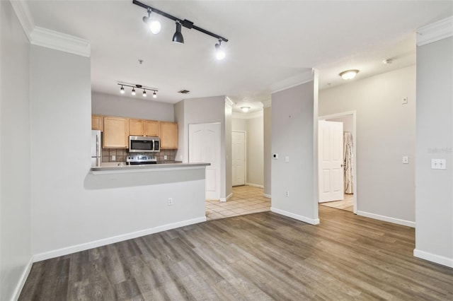 unfurnished living room with crown molding and light wood-type flooring