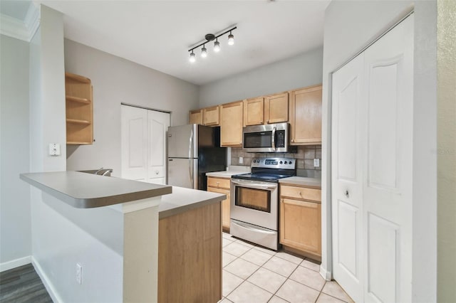 kitchen featuring light brown cabinets, backsplash, appliances with stainless steel finishes, light tile patterned flooring, and kitchen peninsula