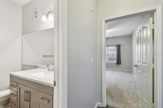 bathroom featuring vanity and toilet