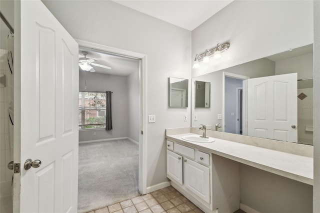 bathroom with tile patterned flooring, vanity, and ceiling fan