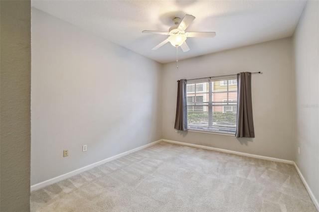 carpeted empty room featuring ceiling fan