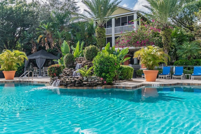 view of pool with a patio area and pool water feature