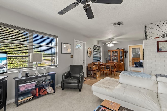 living room featuring light colored carpet and a textured ceiling