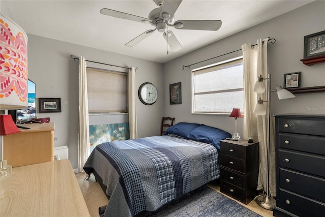 bedroom featuring ceiling fan and light carpet