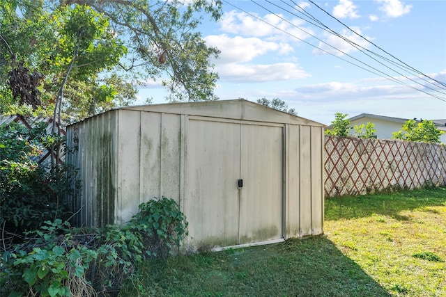 view of outbuilding with a lawn