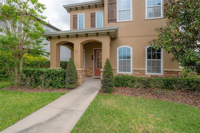 entrance to property with a lawn