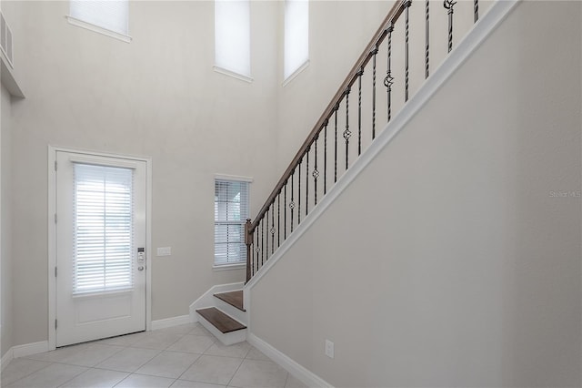 tiled foyer featuring a high ceiling