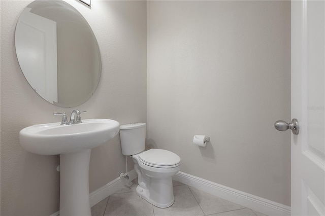 bathroom with tile patterned floors and toilet