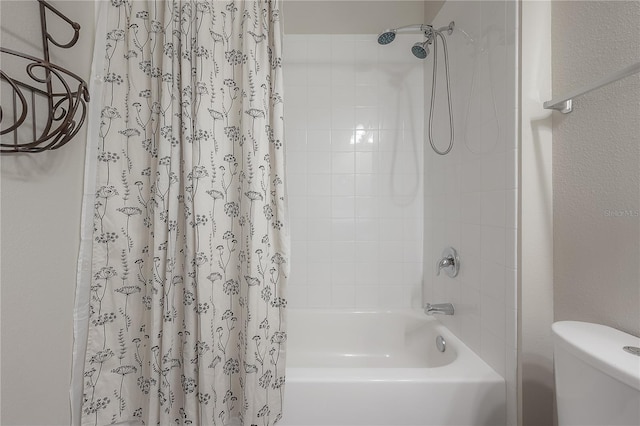 bathroom with shower / tub combo and toilet