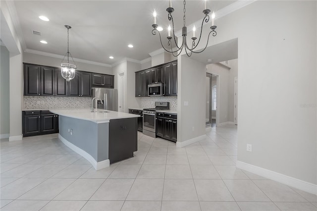 kitchen with light tile patterned floors, stainless steel appliances, tasteful backsplash, and an island with sink