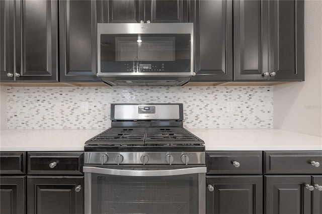 kitchen with appliances with stainless steel finishes and backsplash