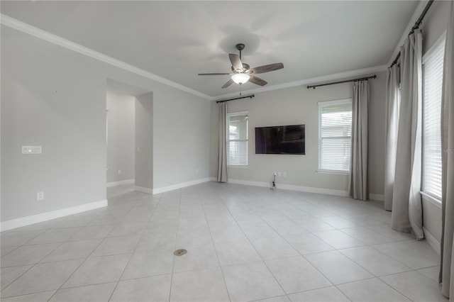 tiled empty room with ceiling fan and crown molding