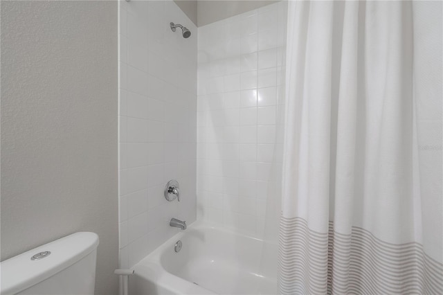 bathroom featuring shower / bath combination with curtain and toilet