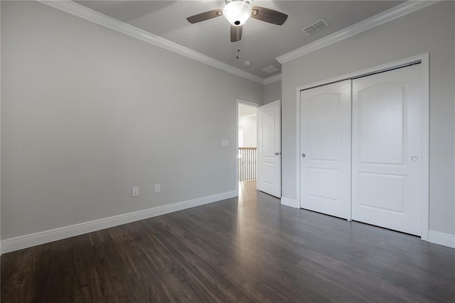 unfurnished bedroom featuring a closet, ceiling fan, ornamental molding, and dark hardwood / wood-style floors