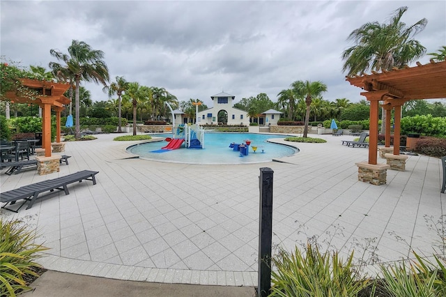 view of pool with a pergola and a patio