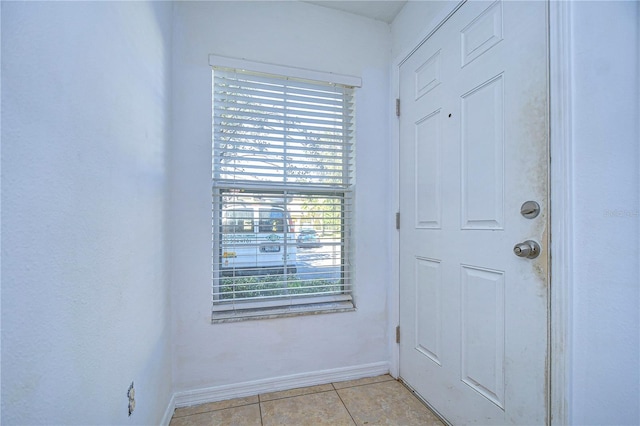 doorway featuring light tile patterned floors and a wealth of natural light