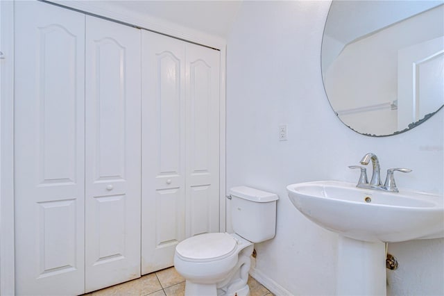 bathroom featuring sink, tile patterned flooring, and toilet