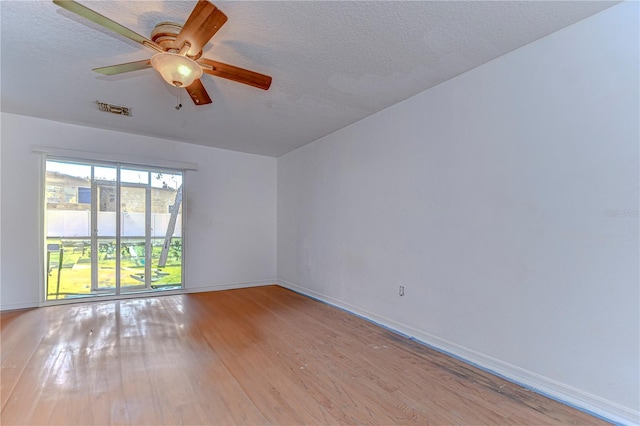 unfurnished room with ceiling fan, light hardwood / wood-style floors, and a textured ceiling