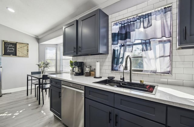 kitchen featuring tasteful backsplash, sink, dishwasher, light hardwood / wood-style floors, and lofted ceiling