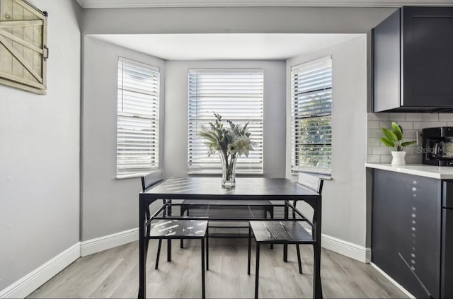 dining space featuring plenty of natural light and light wood-type flooring