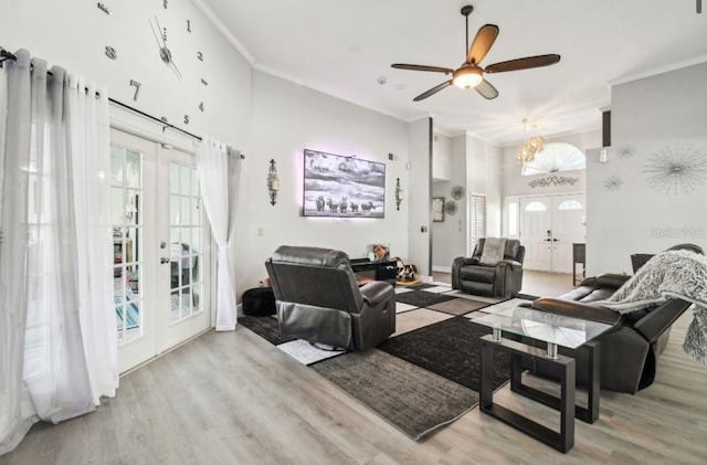 living room with crown molding, ceiling fan, french doors, and light hardwood / wood-style floors