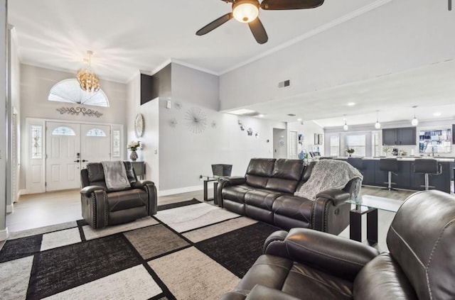 living room with crown molding, french doors, a healthy amount of sunlight, and light hardwood / wood-style floors