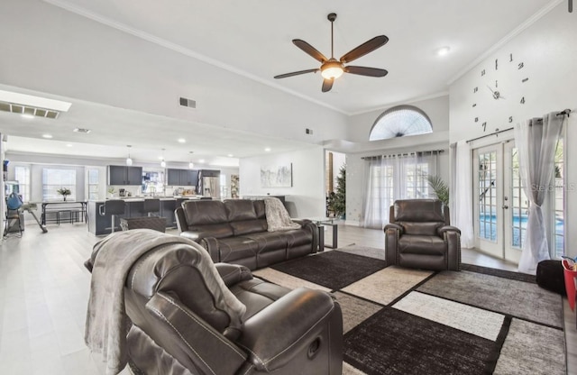 living room featuring french doors, a towering ceiling, plenty of natural light, and ceiling fan