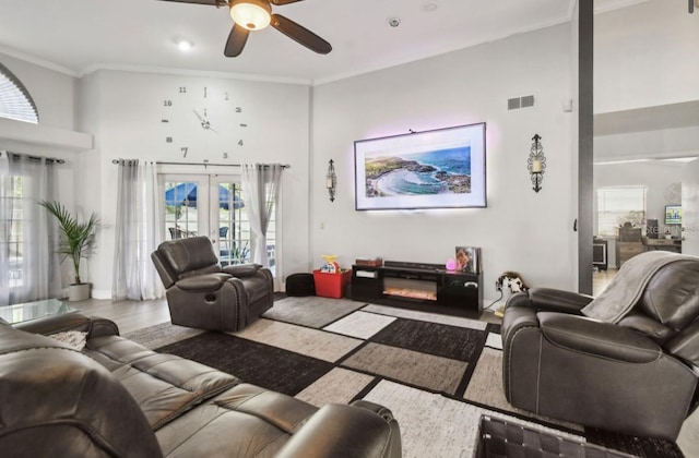 living room with french doors, light hardwood / wood-style flooring, ceiling fan, and crown molding