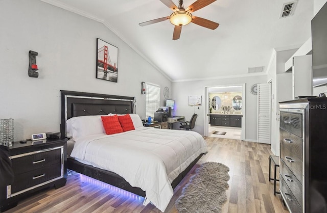 bedroom featuring ensuite bath, ceiling fan, crown molding, wood-type flooring, and lofted ceiling