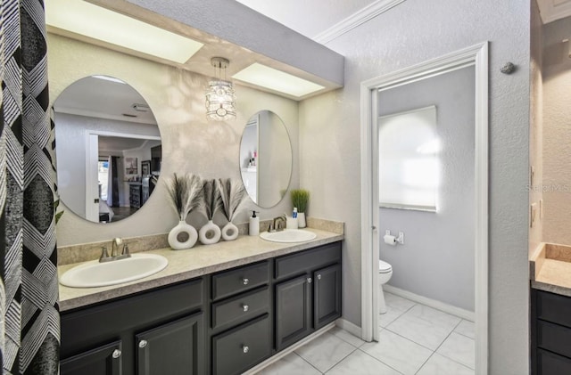 bathroom with tile patterned floors, vanity, toilet, and crown molding