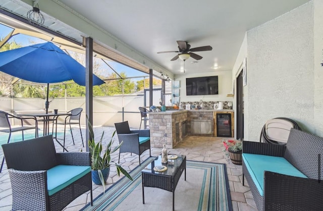 view of patio / terrace with an outdoor hangout area, beverage cooler, a lanai, and ceiling fan