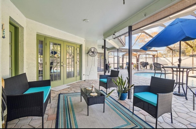 view of patio / terrace featuring glass enclosure, an outdoor hangout area, and french doors