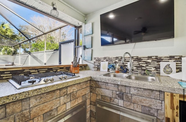 kitchen featuring backsplash, sink, and stainless steel gas cooktop