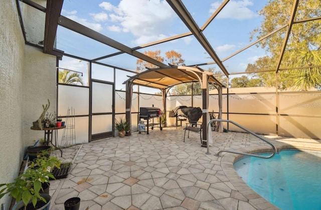 view of patio / terrace featuring glass enclosure and grilling area