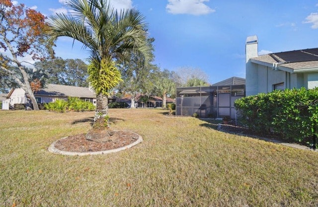 view of yard with a lanai