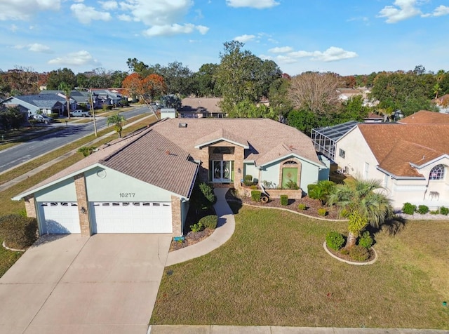 view of front of home with a front yard and a garage