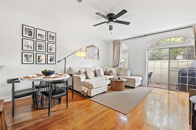 living room featuring ceiling fan and wood-type flooring