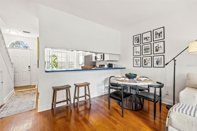 dining room with hardwood / wood-style flooring