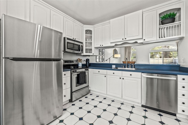 kitchen featuring sink, white cabinetry, and stainless steel appliances