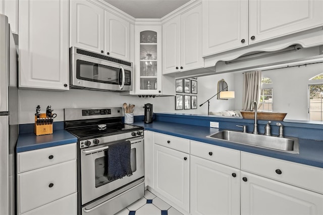 kitchen with white cabinets, sink, and appliances with stainless steel finishes