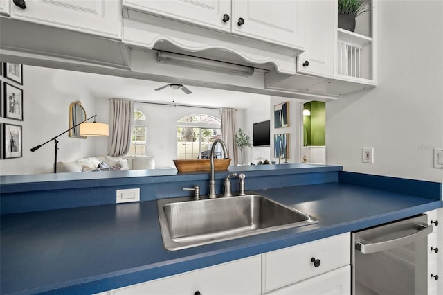 kitchen featuring white cabinetry, stainless steel dishwasher, and sink