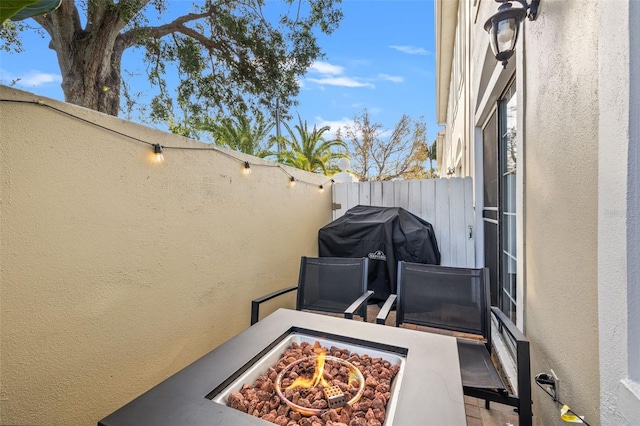 view of patio featuring a fire pit and a grill